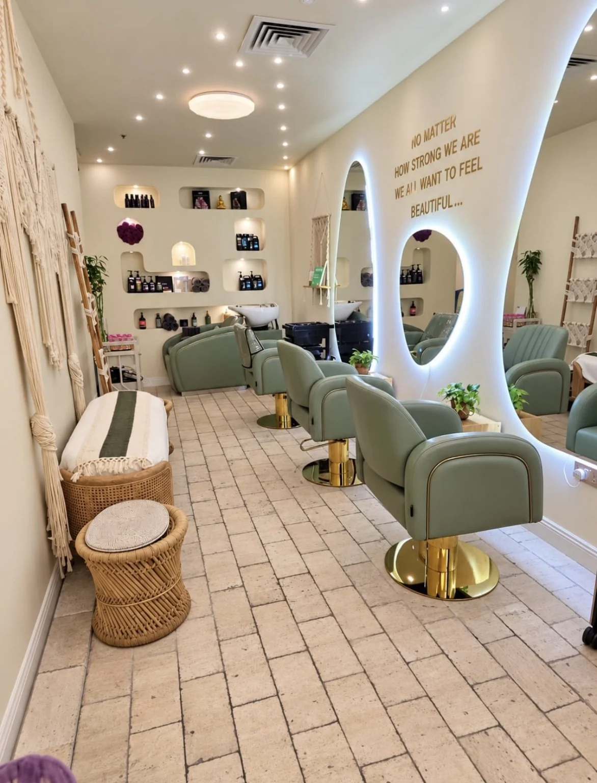 BellaPharma salon interior with sage green styling chairs and illuminated mirrors in Al Barsha 3